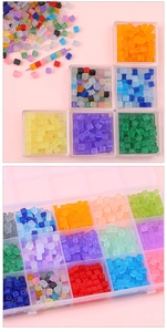 Macro view of 5x5mm frosted square glass beads organized in a divided storage box