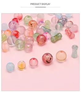 Macro shot of colorful frosted glass beads with gold foil foil for DIY jewelry making