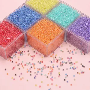 Macro shot of colorful 4mm glass seed beads in six storage boxes for DIY craft jewelry