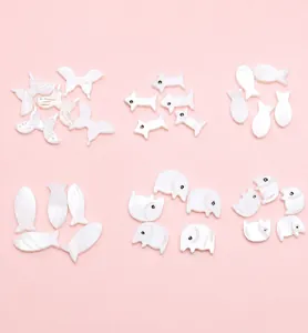 Detailed view of white mother-of-pearl animal charms for DIY jewelry making