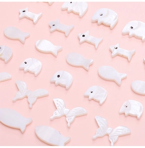Detailed macro view of white mother of pearl animal shape beads for DIY jewelry making