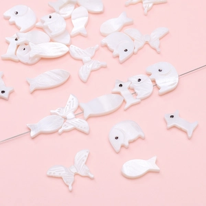 Handmade white shell beads in animal shapes like fish and butterfly for DIY jewelry making