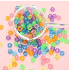 Close-up of colorful luminous acrylic barrel beads for DIY jewelry making crafts