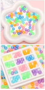 Detailed macro view of colorful luminous acrylic barrel beads for DIY jewelry making