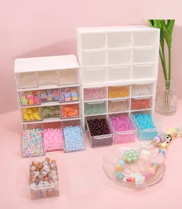 Close-up of white 9-grid acrylic organizer drawers with colorful beads for DIY crafts