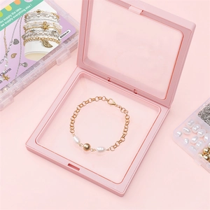 DIY jewelry making kit featuring gold chain bracelet with pearls in pink suspension box