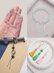 Macro detail of glass lotus charms and colorful silk tassels for DIY jewelry making