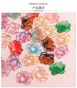 Macro view of transparent glass lotus flower charms with golden glitter for DIY jewelry making