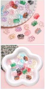 Macro detail of mixed color glass lotus charms for DIY handmade jewelry and hair ornaments