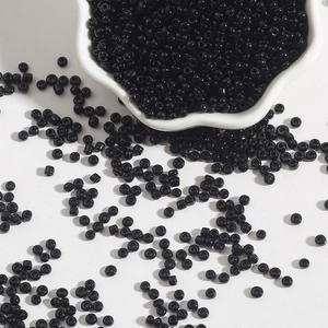 Glossy black 2-4mm glass seed beads for DIY jewelry making in a white ceramic bowl