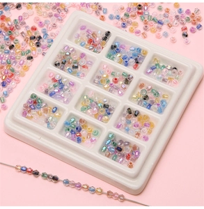Close-up of 4mm faceted iridescent crystal beads in a 12-slot storage box for DIY jewelry