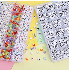 Macro shot of 24-grid DIY jewelry box with acrylic alphabet and heart beads