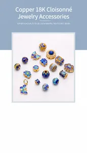 Macro detail of 18K gold-plated Cloisonne beads with enamel butterfly and lotus motifs