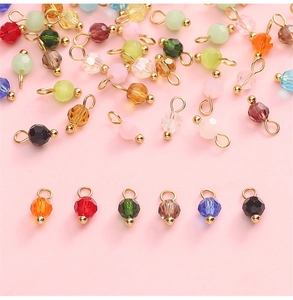 Macro view of multi-colored faceted glass pendants with gold bails for DIY jewelry making