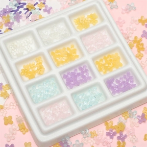 Cuentas de flores de resina en colores macaron en caja de 12 compartimentos para joyería
