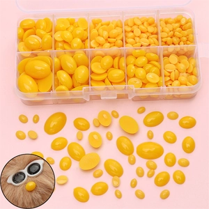 Yellow oval acrylic safety eyes set for DIY plush toys in a transparent plastic storage box