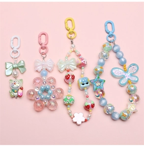 Colorful beaded keychains featuring macaron-style charms and cartoon kitten figures