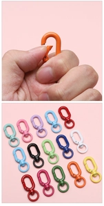 Macro shot of colorful spring snap hooks showing metal mechanism and matte finish