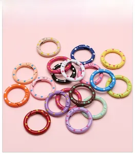 Detailed view of colorful polka dot 25mm round spring snap hooks for DIY jewelry