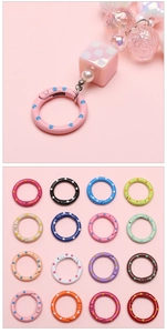 Macro detail of 25mm colorful polka dot alloy spring buckles for DIY jewelry making