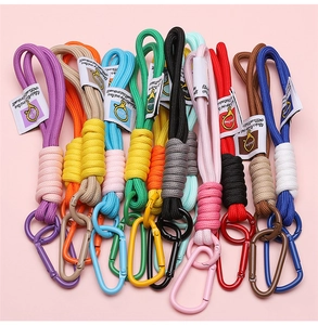 Close-up of colorful braided nylon lanyards with D-shaped carabiners and woven tags