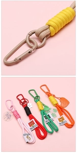 Macro detail of hand-woven colorful keychain ropes with spring buckles and charms