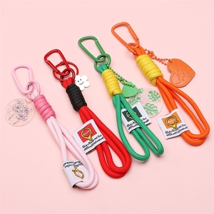 Colorful hand-woven cotton rope keychains with diverse floral and heart-shaped charms