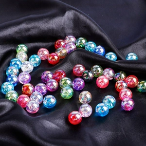 Colorful iridescent acrylic round beads for DIY jewelry making on black silk background