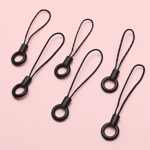 Universal black nylon zipper pull cords and phone lanyards with orange accents on pink background