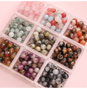Macro shot of 8mm faceted natural stone beads in organized storage for DIY jewelry