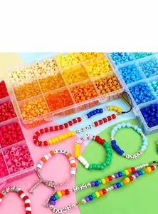 Detailed macro view of 24-grid box with vibrant colorful DIY craft beads and letter charms