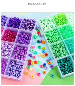 Detailed top view of colorful cylinder plastic beads in two transparent divider storage boxes