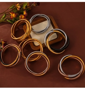 Detail von mehrfarbigen Schlangenarmbändern in Gold, Silber und Roségold-Ausführungen