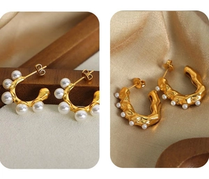 Detailed view of 18k gold plated U-shaped earrings with pearls on silk background