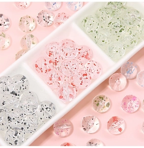 Macro detail of transparent acrylic beads with colorful glitter and center hole for DIY