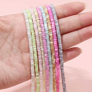 Pastel 2x4mm freshwater shell spacer beads for DIY jewelry making held in hand