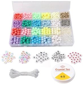 Macro view of 24-compartment bead set with colorful acrylic beads and elastic strings