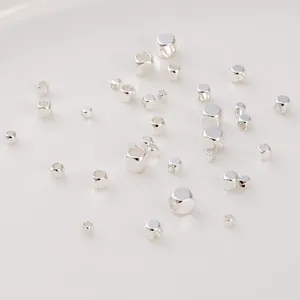 Close-up of polished silver cube spacer beads in various sizes for DIY jewelry making
