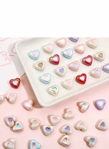 Close-up of colorful acrylic heart beads with pearl luster finish for DIY jewelry