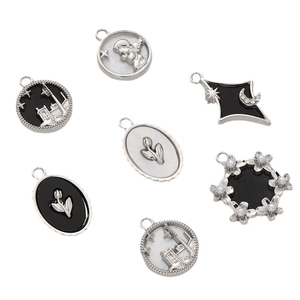 Retro silver pendants with black and white enamel featuring angel and moon motifs