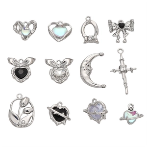 Set of 12 silver alloy charms including moon, heart, and bow shapes with zircon inlay