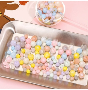 Macro shot of colorful pearlescent acrylic beads for DIY jewelry making in pastel tones