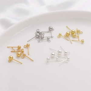 DIY jewelry earring studs with loop hooks in four metallic finishes on ceramic plate