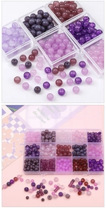 Macro detail of assorted purple glass beads for DIY jewelry making in a plastic storage box