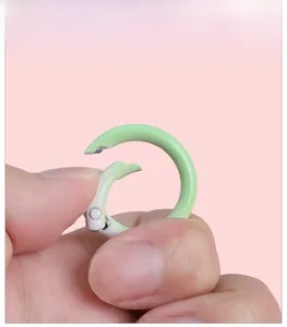 Detail of light green round spring buckle showing manual opening for DIY accessories