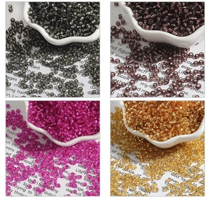 Macro view of 2mm silver-lined glass seed beads in multiple colors for DIY jewelry