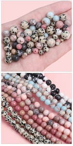 Close-up of assorted natural stone beads for DIY jewelry making with smooth texture