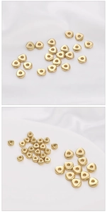 Macro view of polished 14K gold filled triangular spacer beads for DIY jewelry making