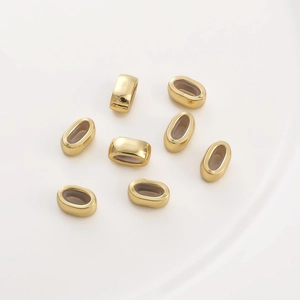 Set of 8 gold oval slider beads for DIY jewelry making on white background