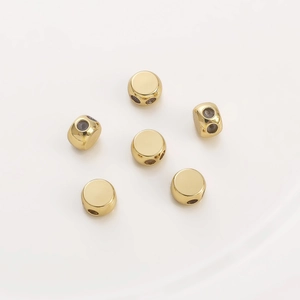 Set of 6 gold plated 14K round spacer beads for DIY jewelry making on white background